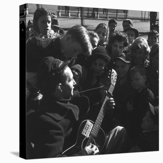 Folk Singer Woody Guthrie Playing Guitar for Group of Children-Eric Schaal-Premier Image Canvas