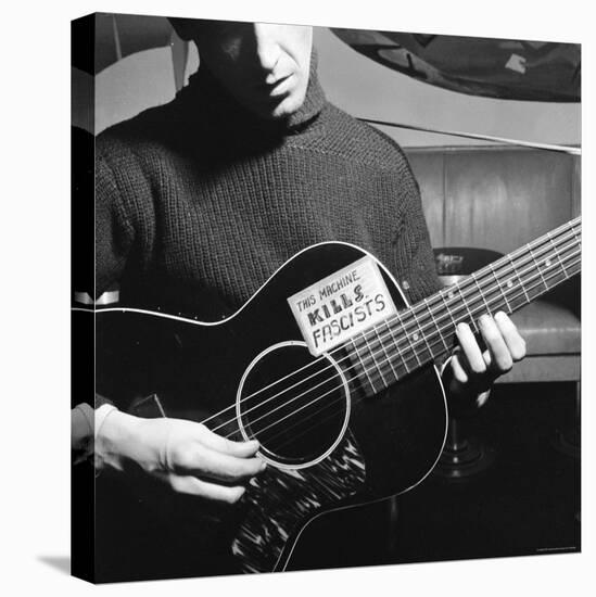 Folk Singer Woody Guthrie Playing Guitar with Sign on It Reading This Machine Kills Fascists-Eric Schaal-Premier Image Canvas