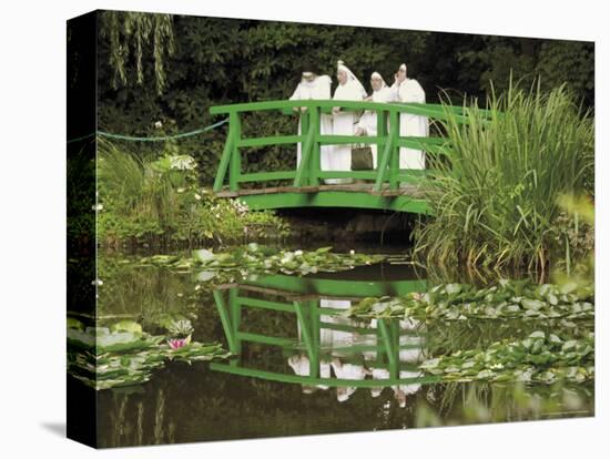 Four Nuns Standing on the Japanese Bridge in the Garden of the Impressionist Painter Claude Monet-David Hughes-Premier Image Canvas