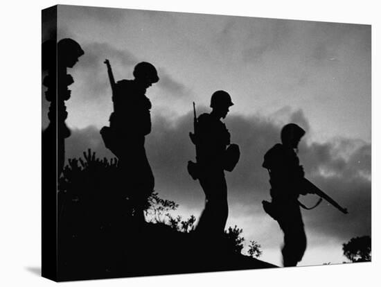 Four Soldiers with Helmets and Rifles Moving on Crest of Ridge, on Patrol at Night-Michael Rougier-Premier Image Canvas