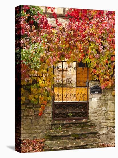 France, Midi-Pyrenees Region, Tarn Department, Cordes-Sur-Ciel, Gate with Autumn Foliage-Walter Bibikow-Premier Image Canvas