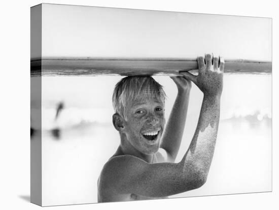 Freckled Surfer Larry Shaw Carrying Surfboard on His Head-Allan Grant-Premier Image Canvas