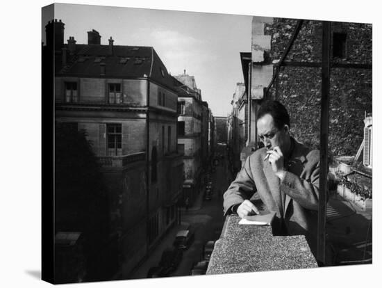 French Writer Albert Camus Smoking Cigarette on Balcony Outside His Publishing Firm Office-Loomis Dean-Premier Image Canvas