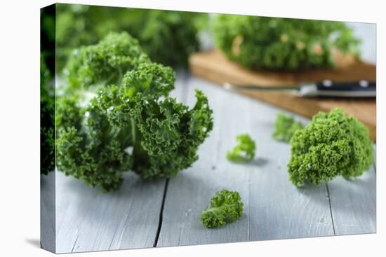 Fresh Kale on Gray Wooden Table-Jana Ihle-Premier Image Canvas