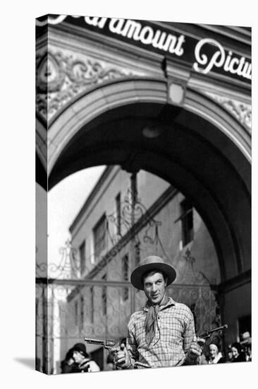 Gary Cooper poses with revolvers in his hands-null-Stretched Canvas