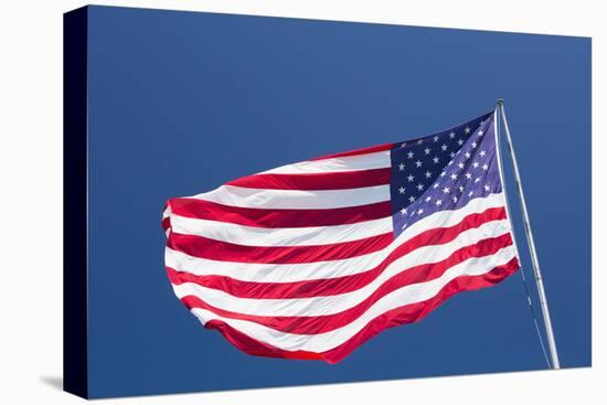 Giant US flag flying beneath a deep blue sky above Truman Avenue, Old Town-David Tomlinson-Premier Image Canvas