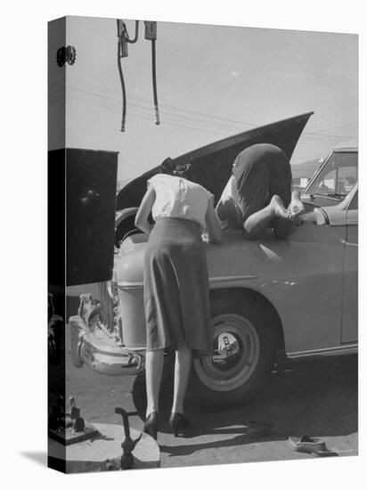 Girl Attendant Looking For Battery For Customer-Allan Grant-Premier Image Canvas