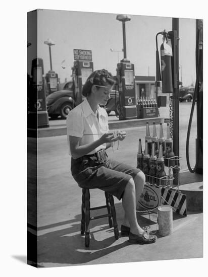 Girl Change Maker Knitting During Slow Moments at the Gilmore Self-Service Gas Station-Allan Grant-Premier Image Canvas