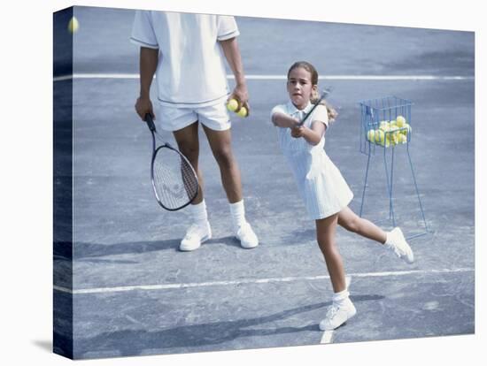 Girl Playing Tennis Under Supervision of a Coach-null-Premier Image Canvas