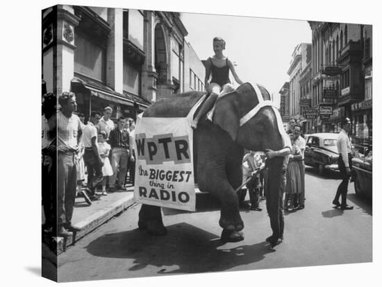 Girl Riding Elephant as a Publicity Stunt for a Radio Station-Peter Stackpole-Premier Image Canvas