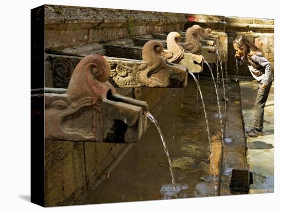 Girl Takes a Drink from the Water Spouts in a Temple Courtyard at Godavari in the Kathmandu Valley-Don Smith-Premier Image Canvas