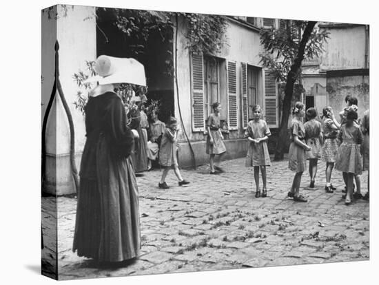 Girls Gathering in the Courtyard of the Mission, Nuns Nearby-null-Premier Image Canvas