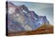Greenland. Kong Oscar Fjord. Ella Island. Hiker dwarfed by rocky mountains.-Inger Hogstrom-Premier Image Canvas