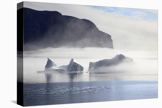 Greenland, Uummannaq. Morning fog envelopes Icebergs Uummannaq Fjord Bay-Miva Stock-Premier Image Canvas