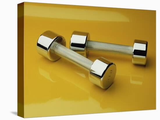 Hand Weights on a Reflective Yellow Surface-null-Premier Image Canvas