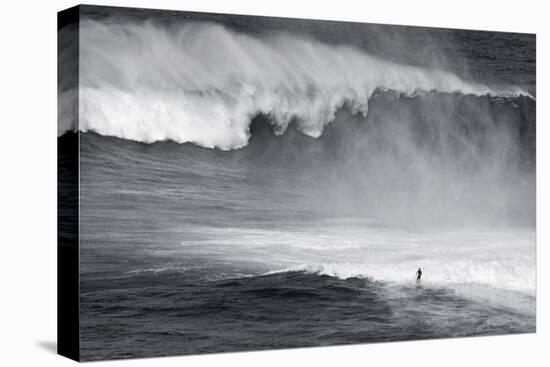 Hawaii, Maui. Lone Figure Surfing Monster Waves at Pe'Ahi Jaws, North Shore Maui-Janis Miglavs-Premier Image Canvas