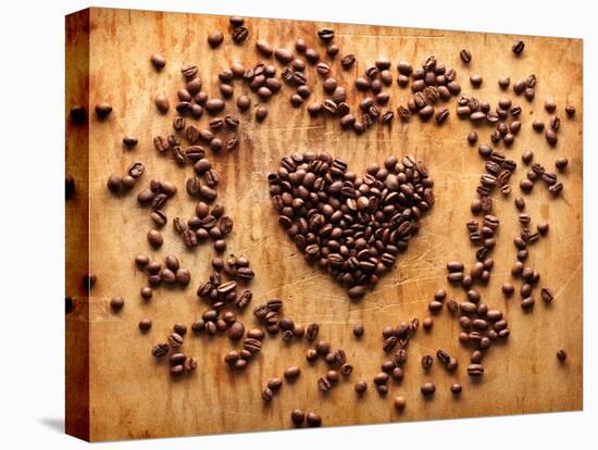 Heart Shape From Brown Coffee Beans, Close-Up On Old Vintage Wooden Background-ouh_desire-Stretched Canvas