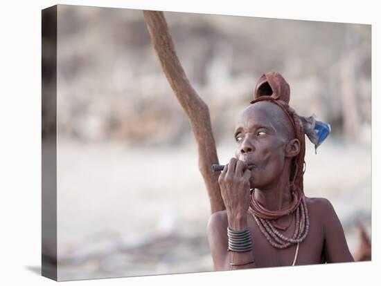 Himba Woman Smokes Outside Her Thatched Home in the Tiny Village, Purros, Namibia, Africa-Kim Walker-Premier Image Canvas