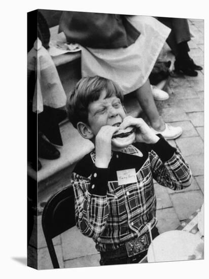Hollywood Child Timmy Garry at Children's party Dressed in Cowboy Outfit eating a Hamburger-J^ R^ Eyerman-Premier Image Canvas