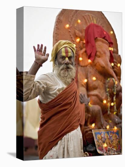 Holy Man in Front of a Ganesh Statue Draped in Fairy Lights at the Hindu Festival of Shivaratri-Don Smith-Premier Image Canvas