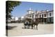 Horse and carriage riding along sand streets with brotherhood houses behind, El Rocio, Huelva Provi-Stuart Black-Premier Image Canvas