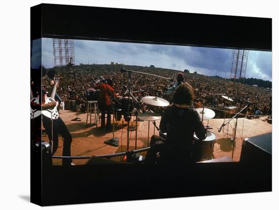 Huge Crowd Listening to a Band Onstage at the Woodstock Music and Art Festival-Bill Eppridge-Premier Image Canvas