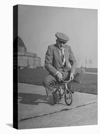 Humorous of Man Riding Tiny Bicycle-Wallace Kirkland-Premier Image Canvas