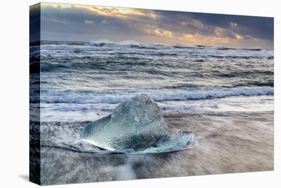 Iceberg from melting glacier on black sand beach near Jokulsarlon glacier lagoon-Ed Hasler-Premier Image Canvas
