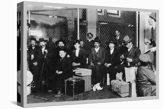 Immigrant Men Sitting at Ellis Island-null-Stretched Canvas