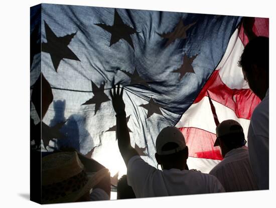 Immigration Rights Demonstrators Hold a U.S. Flag Aloft During a March Along Wilshire Boulevard-null-Premier Image Canvas