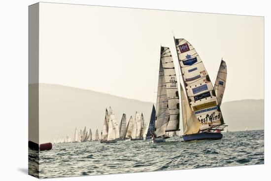 In the start of the yachting regatta Centomiglia in 2012 in front of the harbour of Bogliaco, Lake -Rasmus Kaessmann-Premier Image Canvas