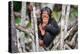 Infant Chimpanzee sitting in mangrove tree eating fruit, Africa-Eric Baccega-Premier Image Canvas