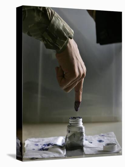 Iraqi Security Forces Member Inks His Finger after Casting His Vote at a Polling Center in Iraq-null-Premier Image Canvas