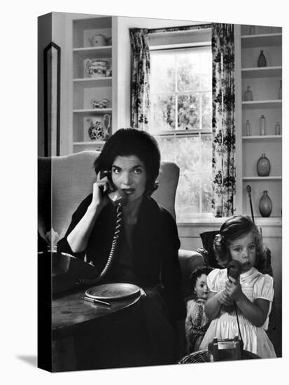 Jackie Kennedy, Wife of Senator John Kennedy, Talking on the Telephone as her daughter mimics her-Alfred Eisenstaedt-Premier Image Canvas