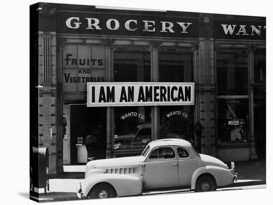 Japanese American shop owner in Oakland, CA hopes to avoid internment after Pearl Harbor, 1942-Dorothea Lange-Premier Image Canvas