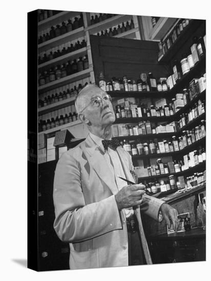 John Rogers in the Prescription Room of His Old-Fashioned Pharmacy-null-Premier Image Canvas