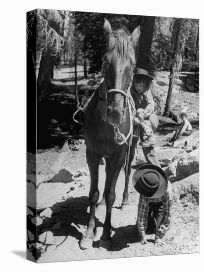 Judy Gordon Mounting Horse with Help of Sister Becky Gordon-Allan Grant-Premier Image Canvas