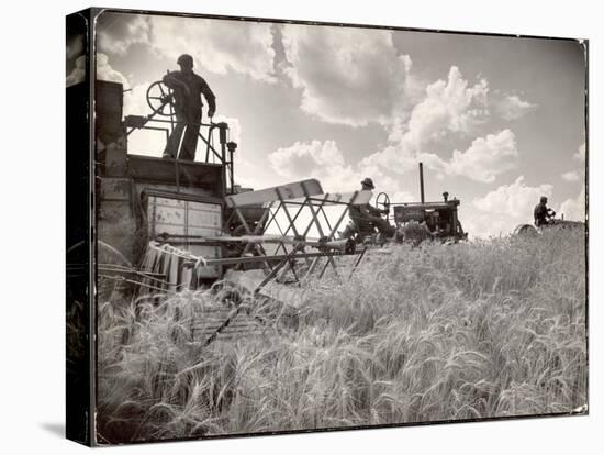 Kansas Farmer Driving Farmall Tractor as He Pulls a Manned Combine During Wheat Harvest-Margaret Bourke-White-Premier Image Canvas