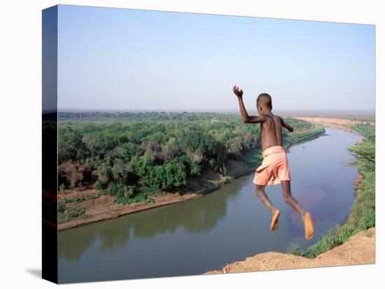 Karo Boy Leaps Off a Cliff Over the Omo River, Ethiopia-Janis Miglavs-Premier Image Canvas