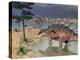 Kentrosaurus Dinosaurs Walking in the Water Next to Sand and Trees-null-Stretched Canvas