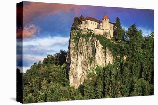 Lake Bled Castle rises on cliffs above Lake Bled, Slovenia at sunset-Miva Stock-Premier Image Canvas