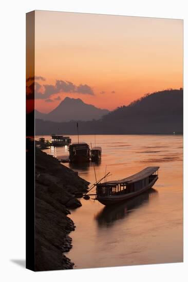 Laos, Luang Prabang, boats on Mekong River at sunset.-Merrill Images-Premier Image Canvas