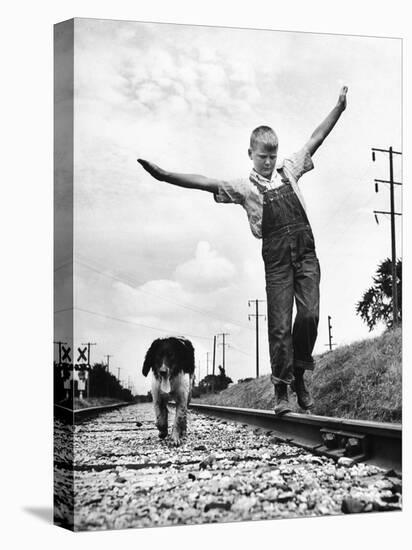 Larry Jim Holm with Dunk, His Spaniel Collie Mix, Walking Rail of Railroad Tracks in Rural Area-Myron Davis-Premier Image Canvas