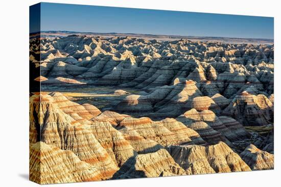 Layers of hoodoo peaks stretching into a flat landscape at the horizon.-Sheila Haddad-Premier Image Canvas