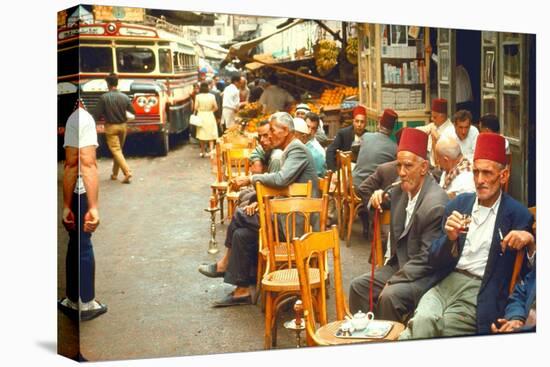 Lebanese Gentlemen sits at a steetside cafe sipping tea and smoking traditional narghile pipes-Carlo Bavagnoli-Premier Image Canvas