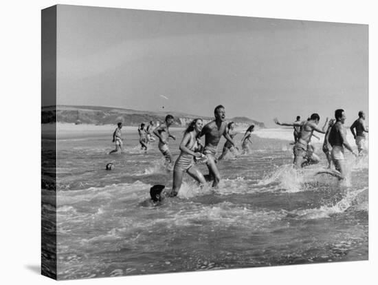Lifeguards and Members of Womens Swimming Team Start Day by Charging into Surf-Peter Stackpole-Premier Image Canvas