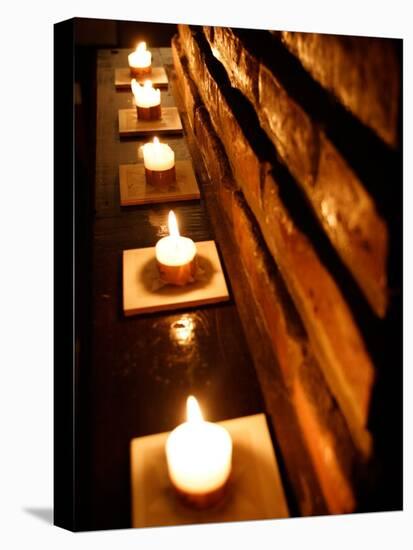 Lighted Candles and Brick Wall-Michele Molinari-Premier Image Canvas