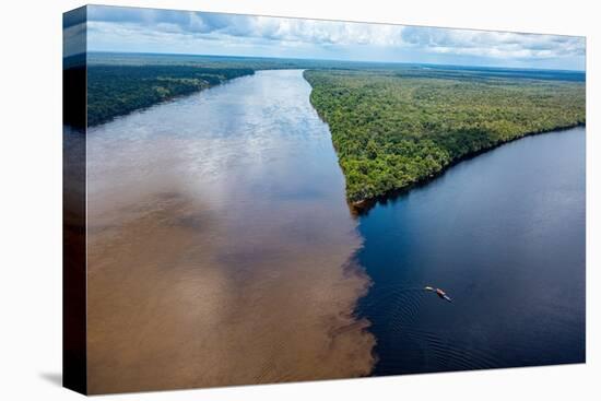 Little boat on the meeting point of the Casiquiare River and black Pasimoni River-Michael Runkel-Premier Image Canvas