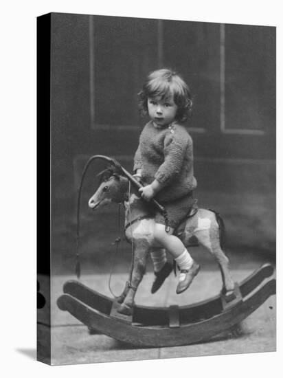 Little Boy on a Very Small Rocking Horse with a Whip in His Hand-null-Premier Image Canvas