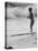 Little Boy Standing on a Surf Board Staring at the Water-Allan Grant-Premier Image Canvas